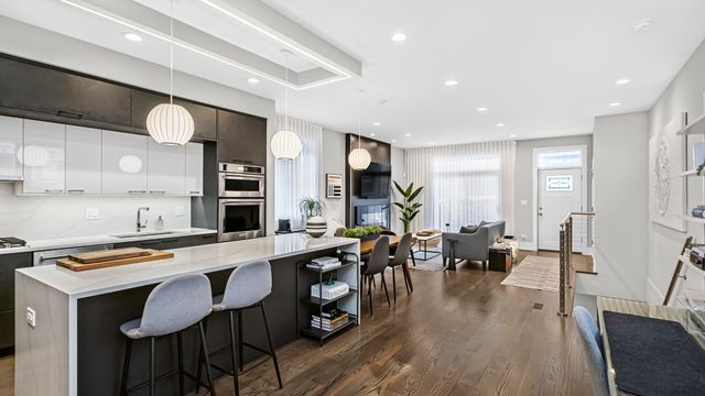 a large kitchen with lots of counter space and furniture