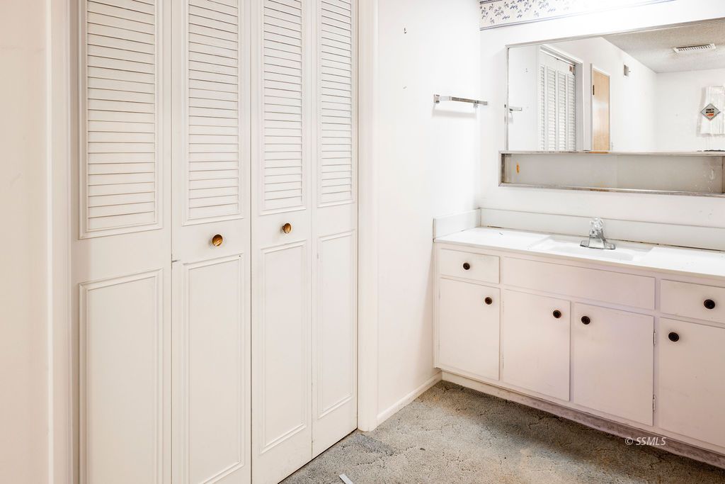 1243 Wayne Street Ridgecrest, CA 93555 - Photo 39 of 42 a bathroom with a sink and a mirror