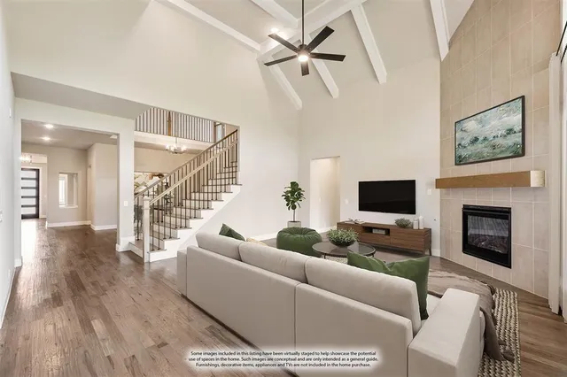 a living room with furniture a fireplace and a flat screen tv