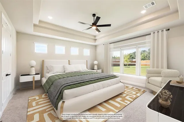 a spacious bedroom with a bed a couch and a window