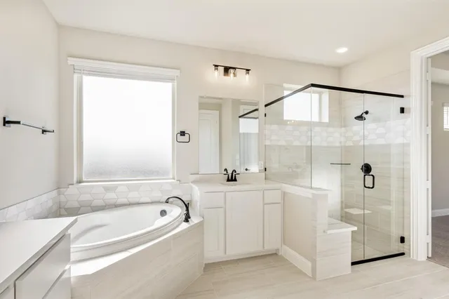 a bathroom with a bathtub and a shower