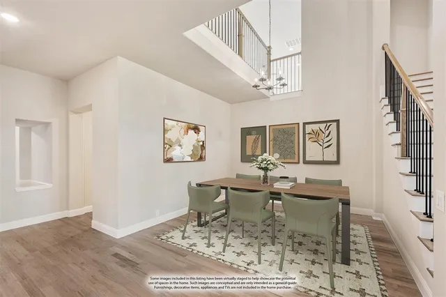 a dining room with wooden floor and a chandelier