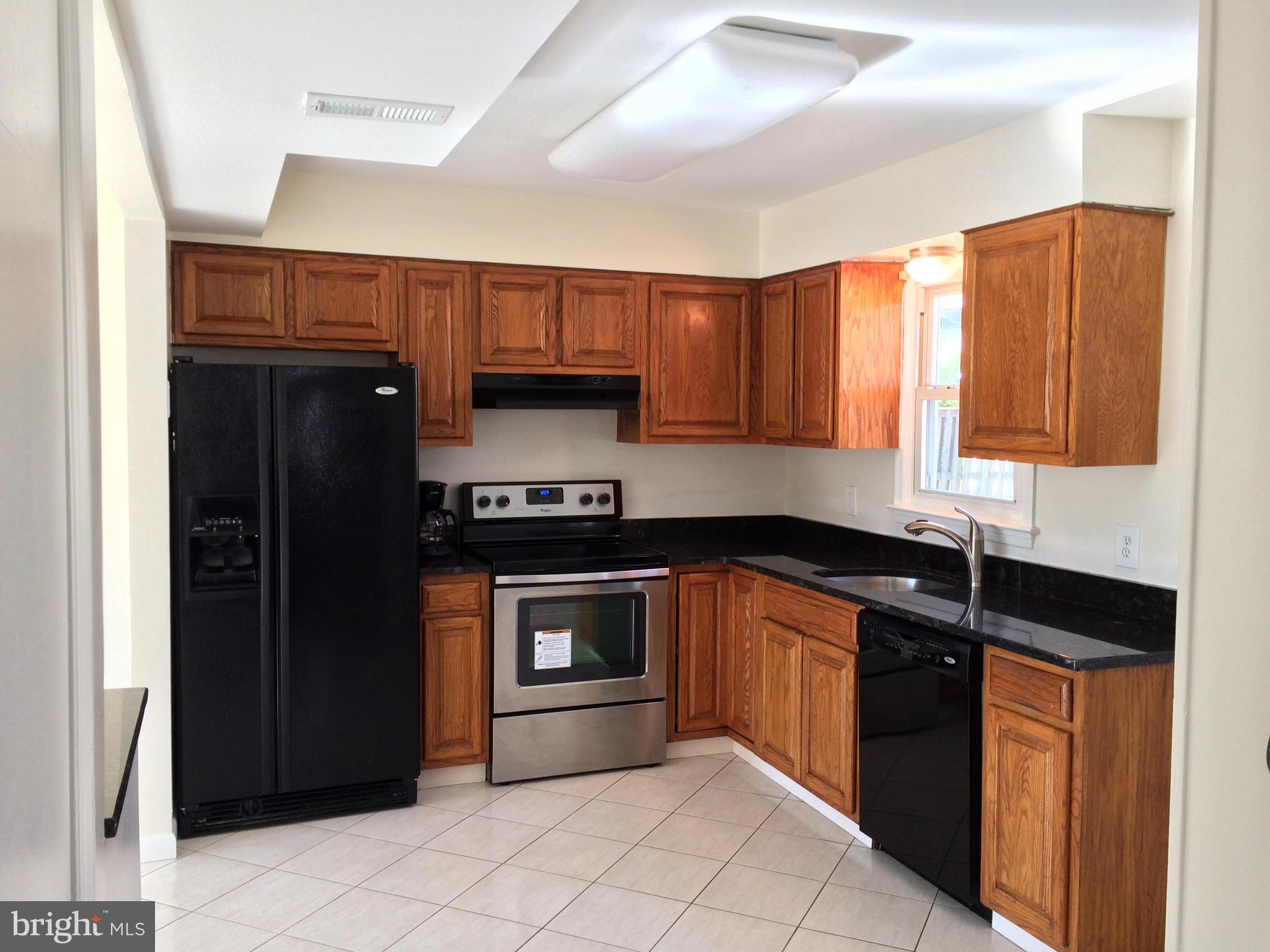 1916 Potomac Road Edgewater, MD 21037 - Photo 5 of 13 a kitchen with granite countertop a refrigerator and a sink