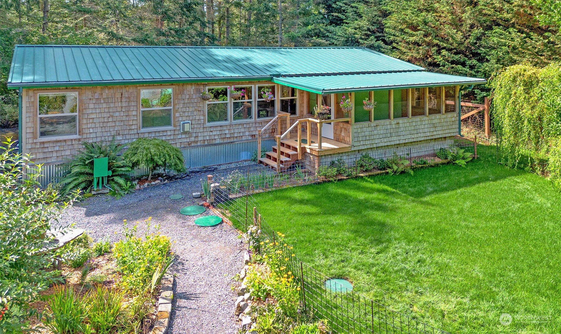 653 Shark Reef Road Lopez Island, WA 98261 - Photo 1 of 33 a front view of a house with a yard