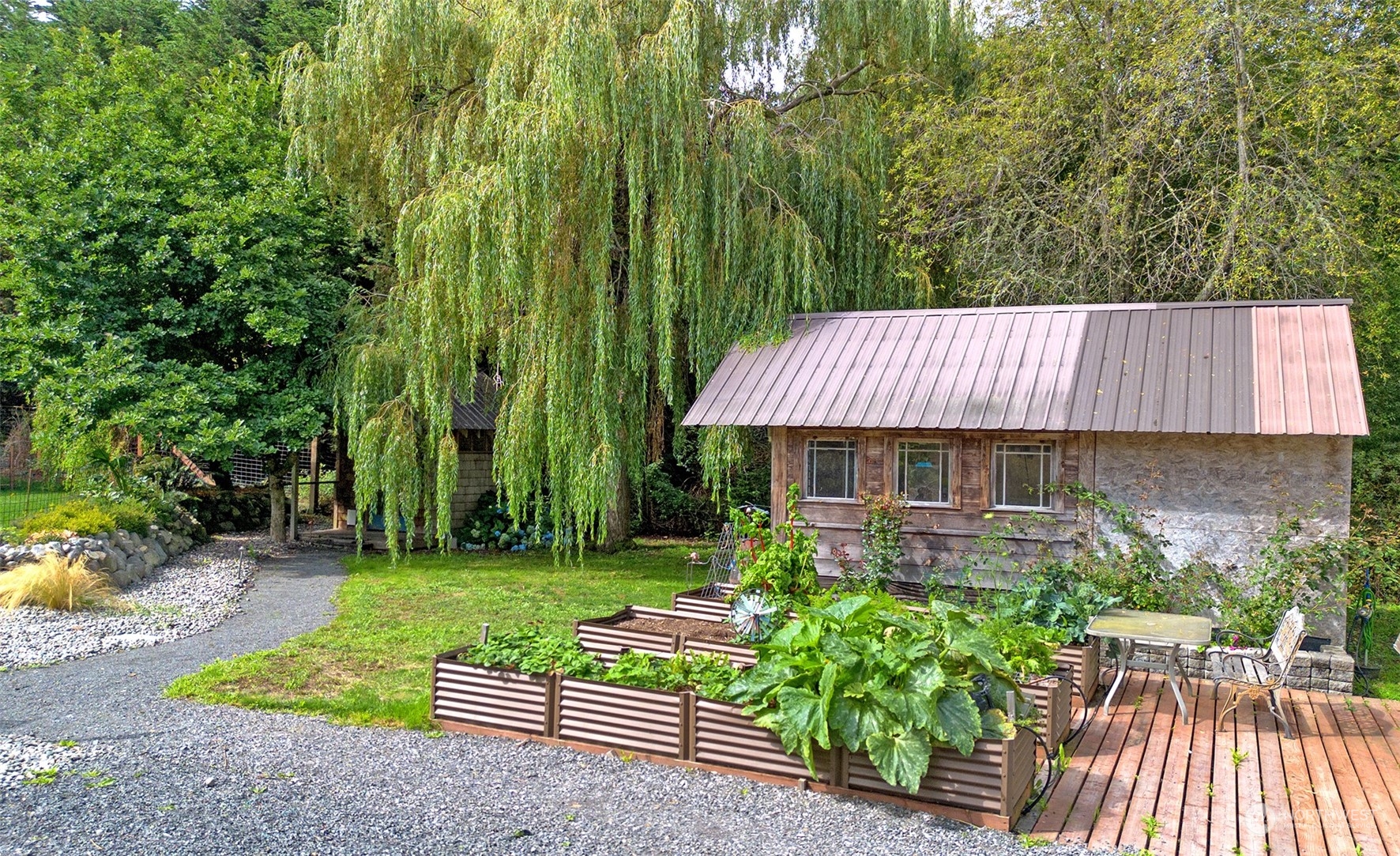 653 Shark Reef Road Lopez Island, WA 98261 - Photo 23 of 33 a view of a backyard with plants and a garden
