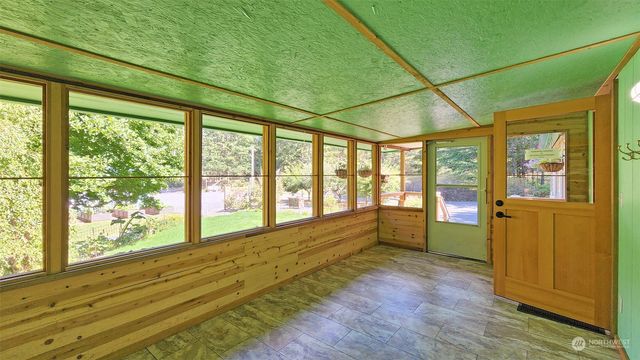 a large room with wooden floor and windows