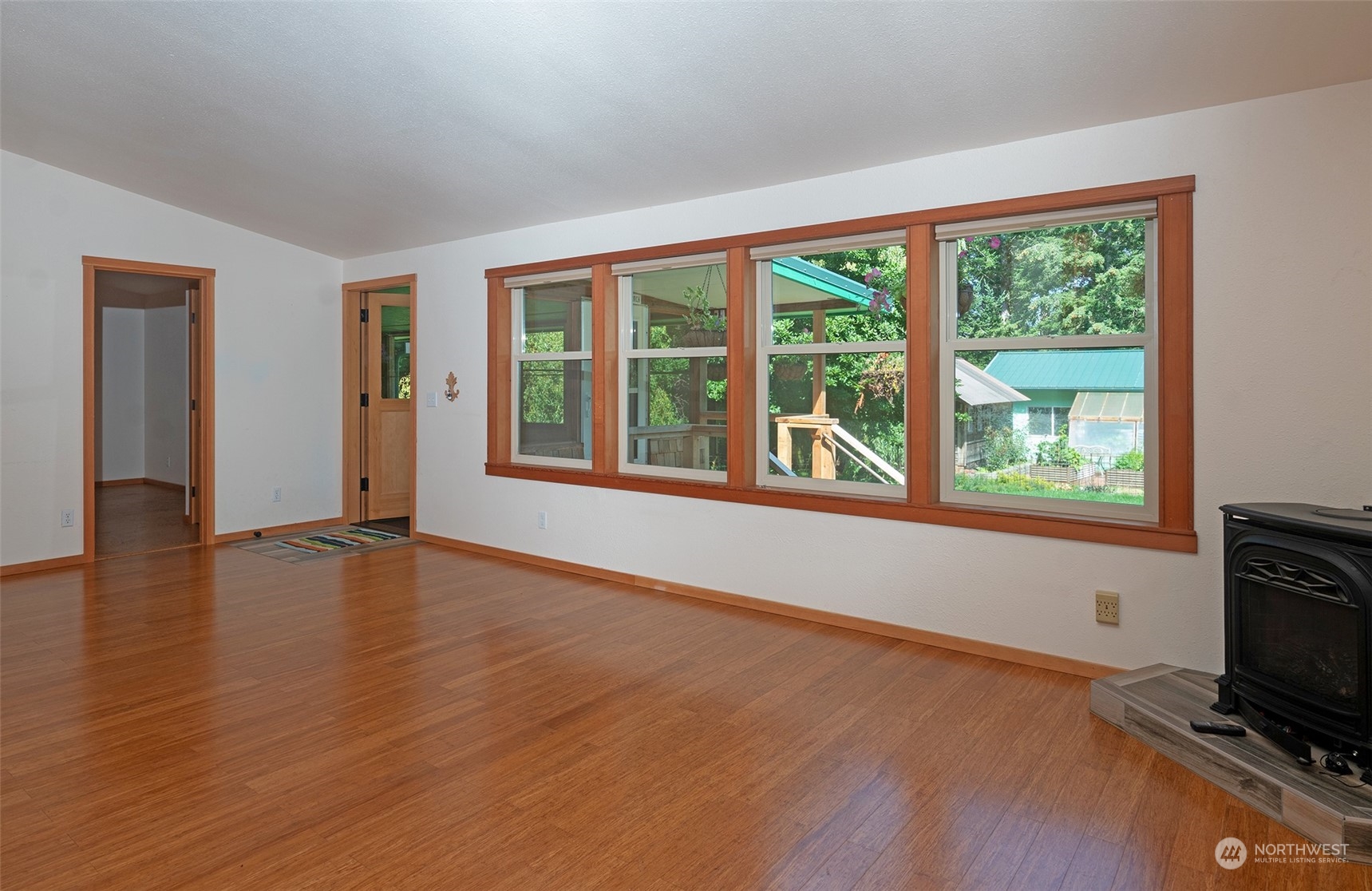 653 Shark Reef Road Lopez Island, WA 98261 - Photo 7 of 33 a view of an empty room with a window and wooden floor
