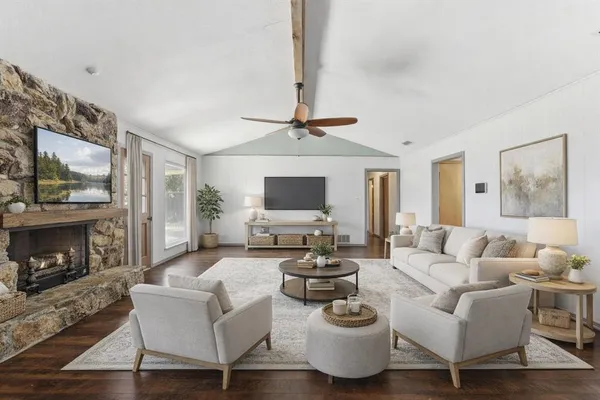 a living room with fireplace furniture and a flat screen tv