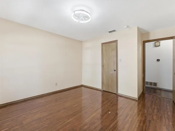 a view of a room with wooden floor