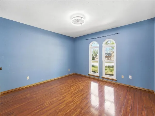 an empty room with windows and natural light
