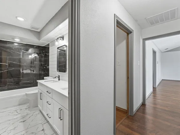 a large bathroom with a double vanity sink a large mirror and shower