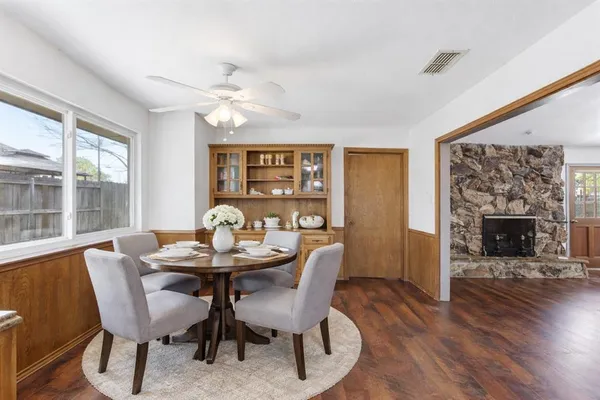 a dining room with furniture a chandelier and wooden floor