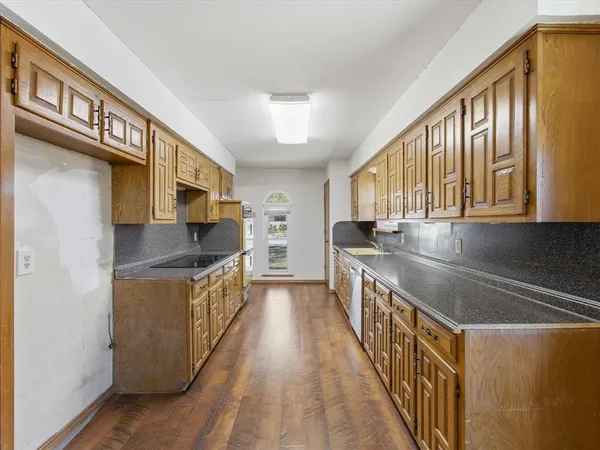 a kitchen with stainless steel appliances granite countertop a stove and a sink