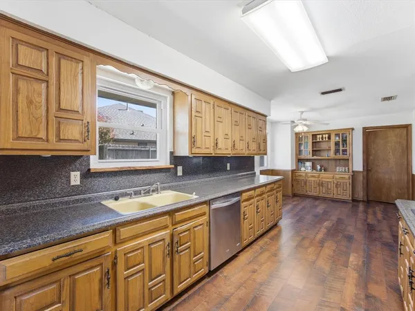 a kitchen with stainless steel appliances granite countertop a sink and cabinets