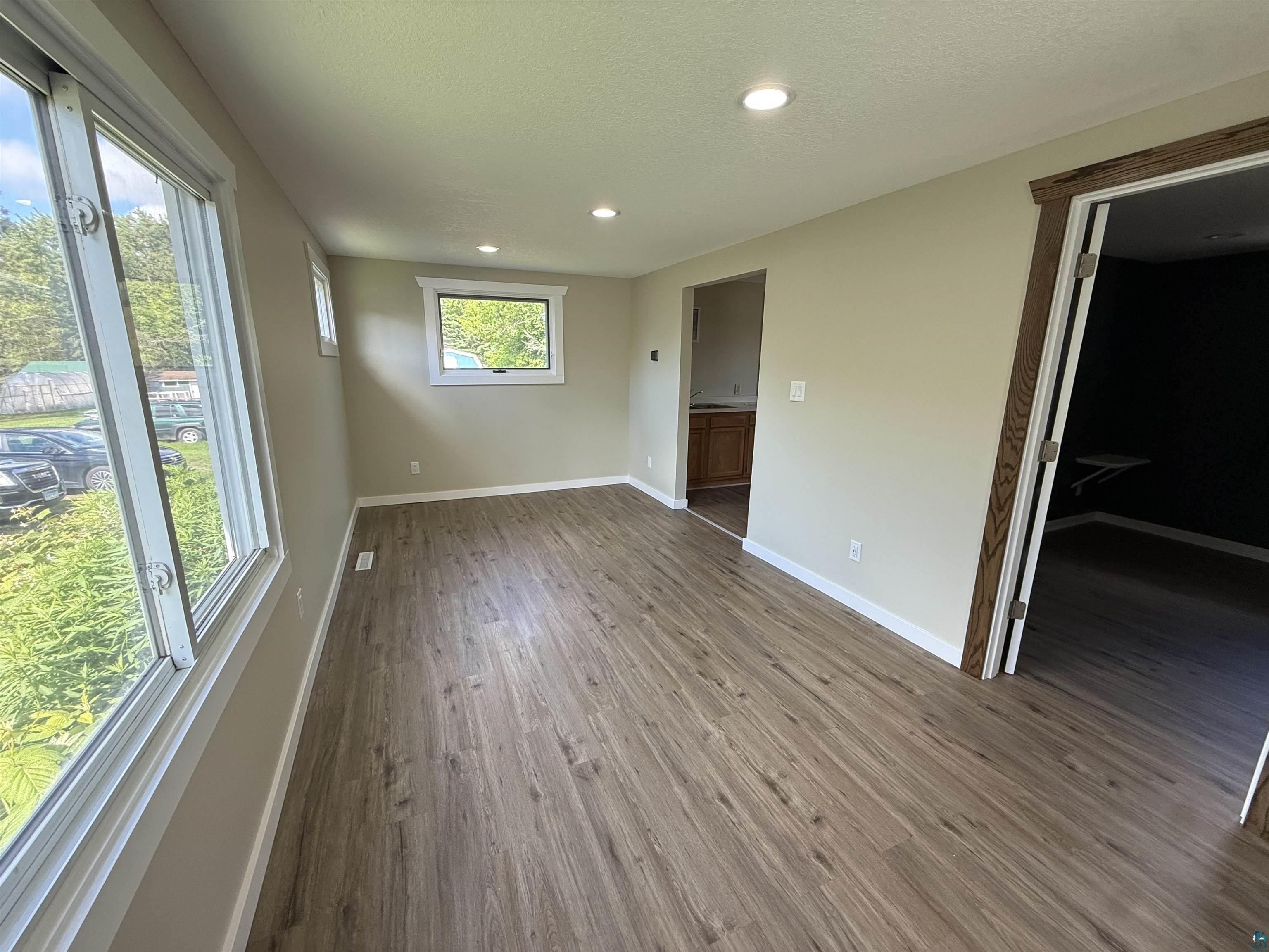 3841 Haines Road Hermantown, MN 55811 - Photo 5 of 11 Spacious room with wood-finish flooring, recessed lighting, and multiple windows
