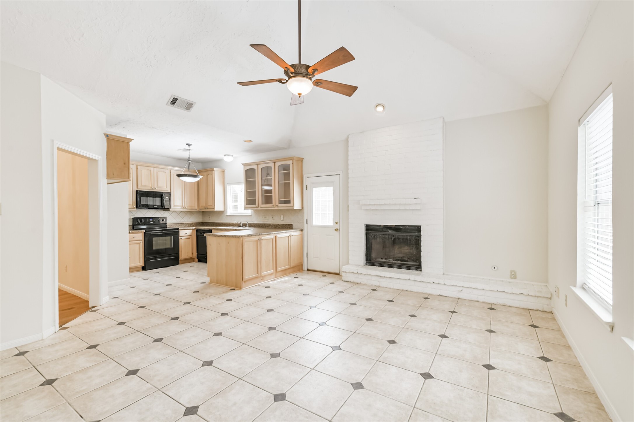 a view of kitchen with windows and refrigerator
