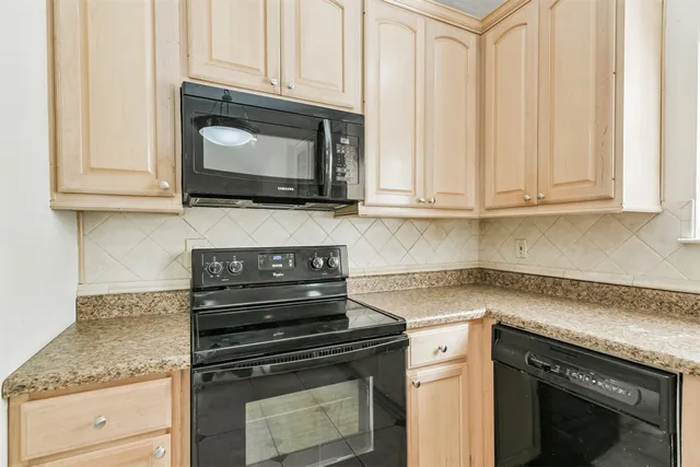 a kitchen with microwave cabinets and stove top oven
