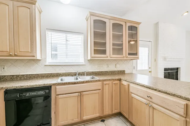 a kitchen with stainless steel appliances granite countertop white cabinets and a granite counter tops