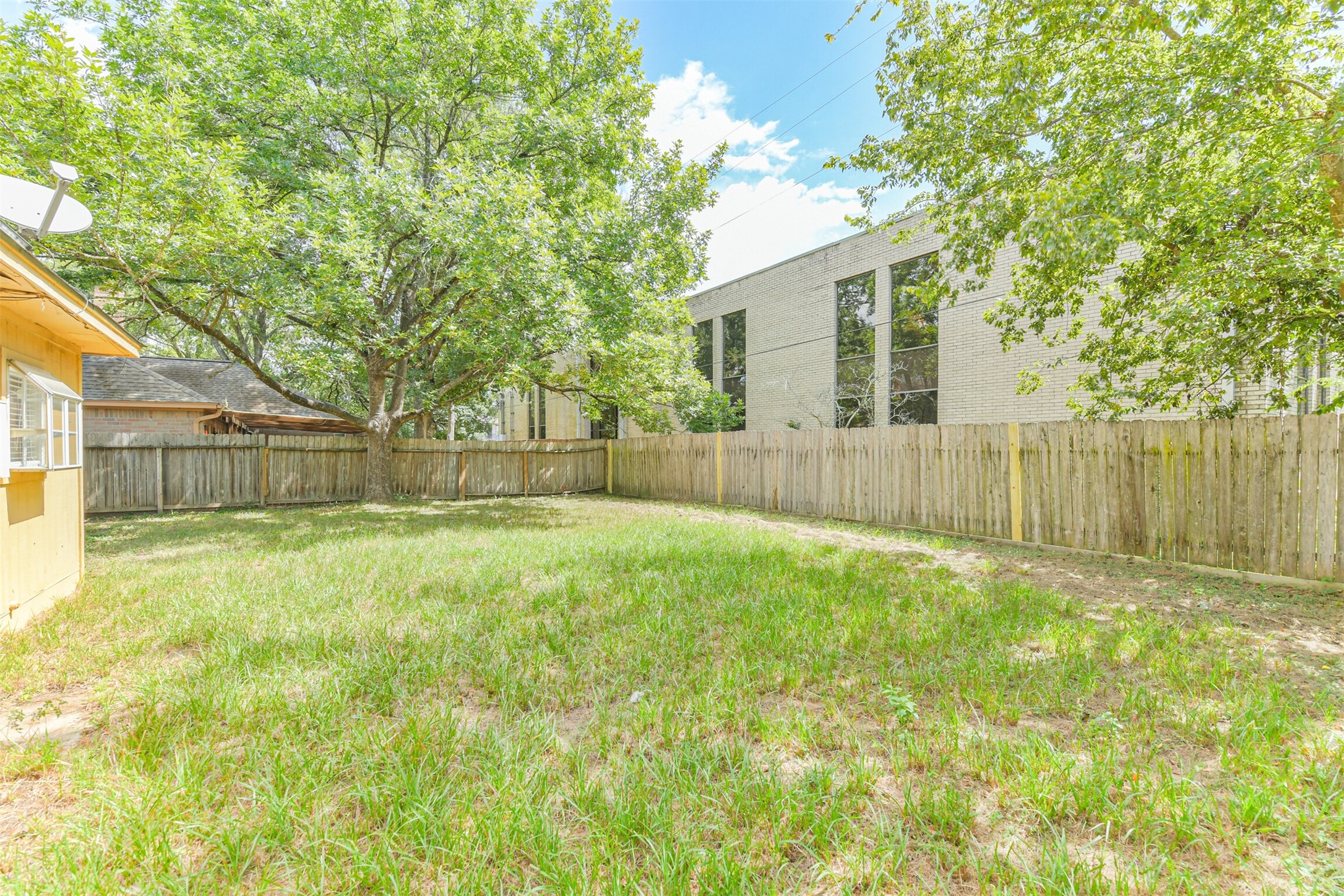 13626 Cedar Point Drive Cypress, TX 77429 - Photo 32 of 34 a view of a backyard with large trees and wooden fence