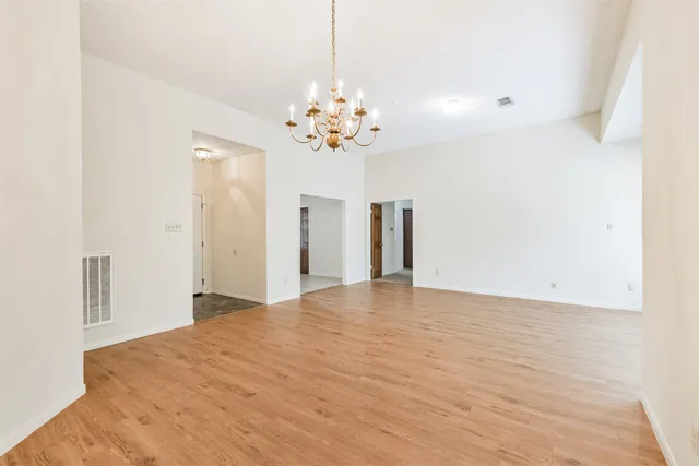a view of a livingroom with a chandelier fan