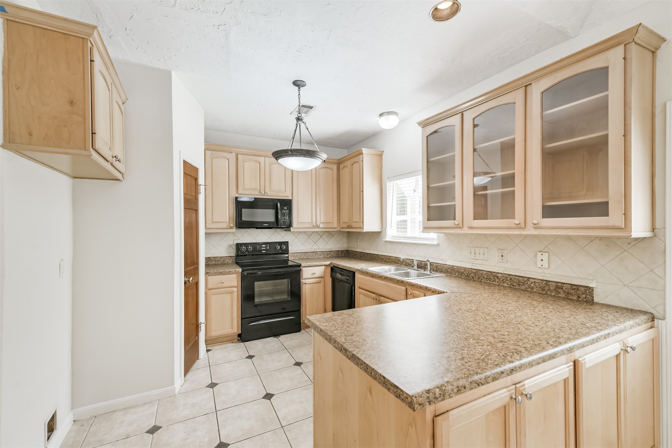 13626 Cedar Point Drive Cypress, TX 77429 - Photo 10 of 34 a kitchen with stainless steel appliances granite countertop a sink stove and refrigerator