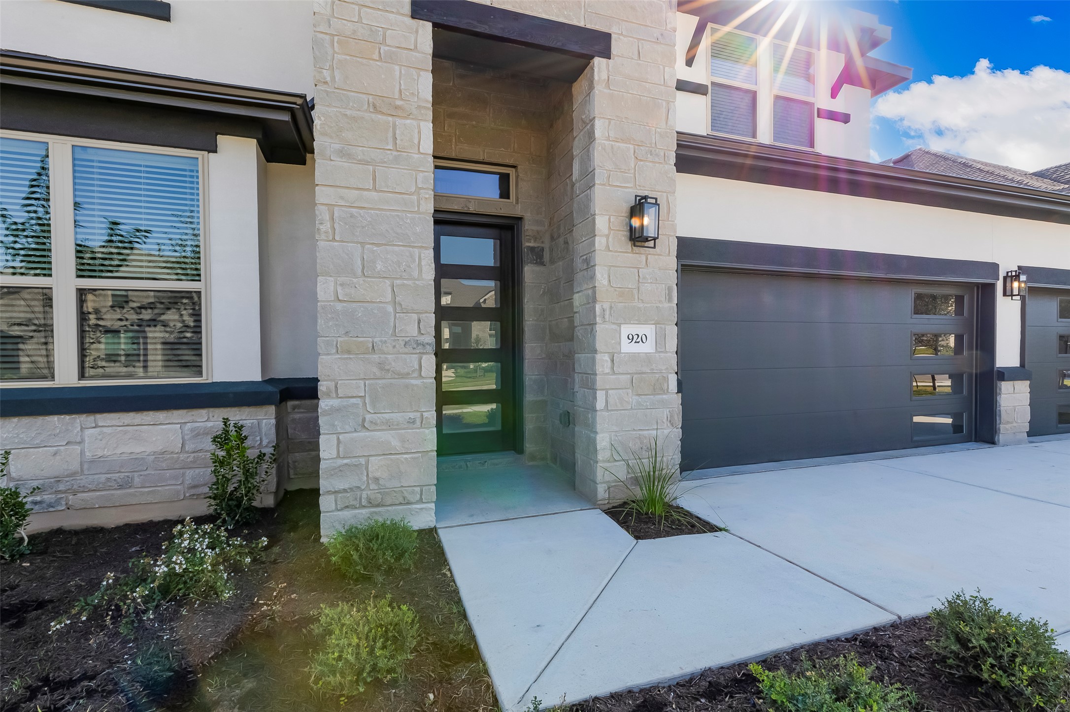 920 Old Gdn Road Leander, TX 78641 - Photo 4 of 39 Property entrance with stone siding, stucco siding, and a garage