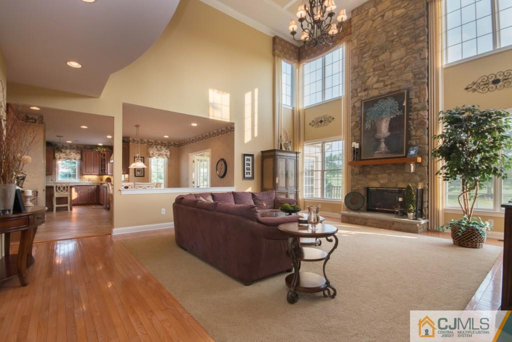 1 Baker Way Pennington, NJ 08534 - Photo 14 of 25 a living room with furniture a fireplace and a chandelier