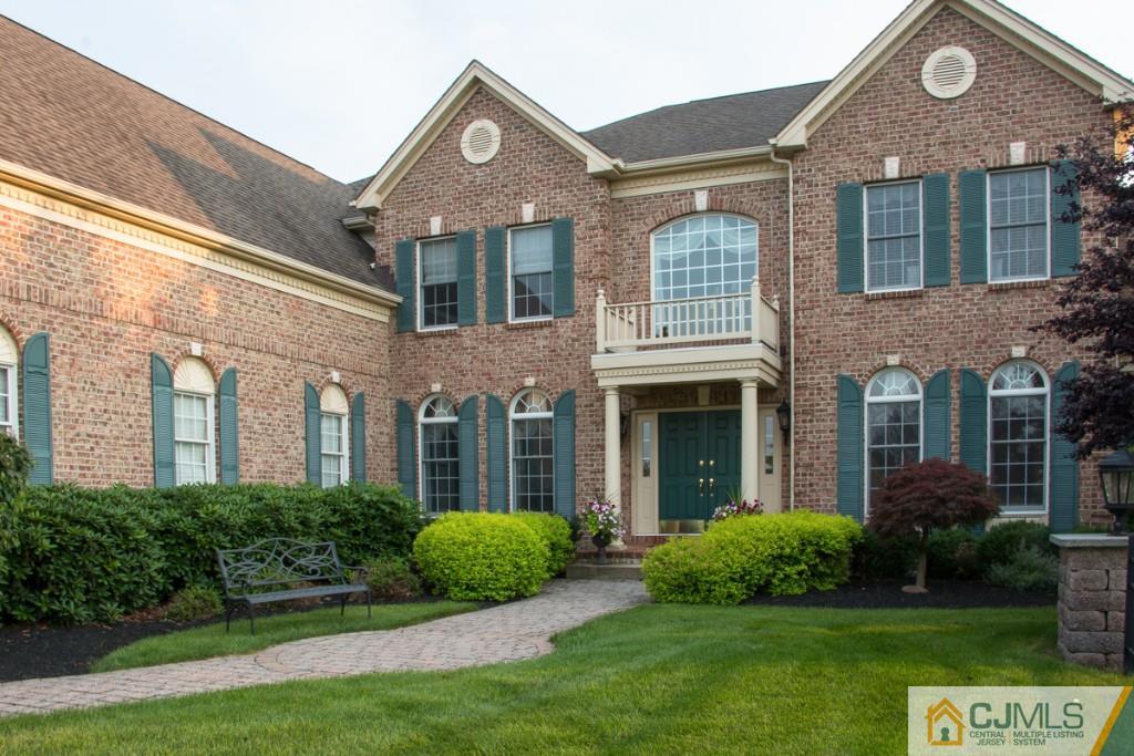 1 Baker Way Pennington, NJ 08534 - Photo 3 of 25 a front view of a house with a yard and garage