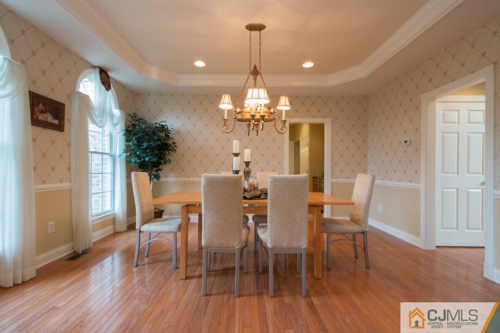 1 Baker Way Pennington, NJ 08534 - Photo 5 of 25 a dining room with furniture a chandelier and wooden floor