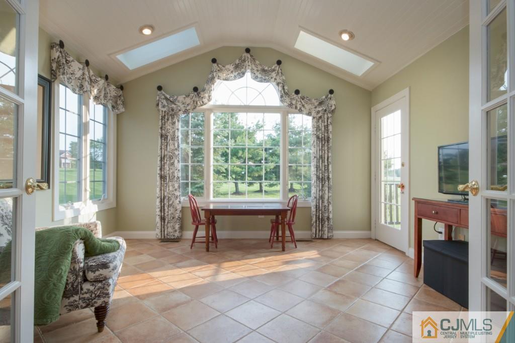 1 Baker Way Pennington, NJ 08534 - Photo 8 of 25 a living room filled with furniture and a chandelier