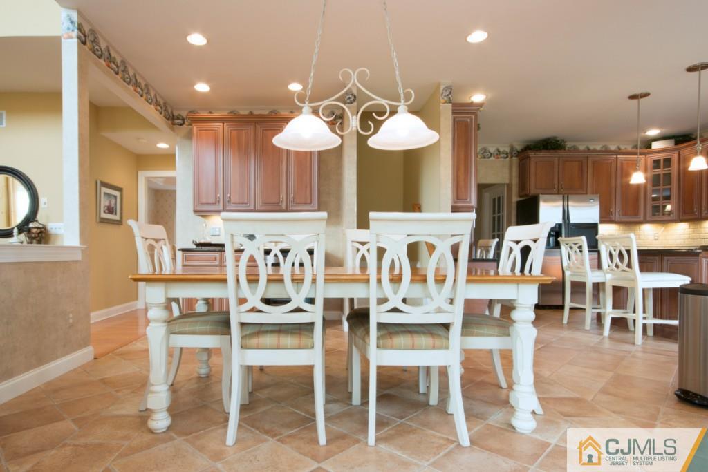1 Baker Way Pennington, NJ 08534 - Photo 10 of 25 a kitchen with lots of white furniture and wooden cabinets