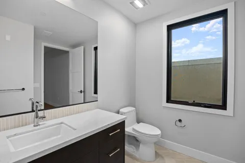a kitchen with a refrigerator and a sink