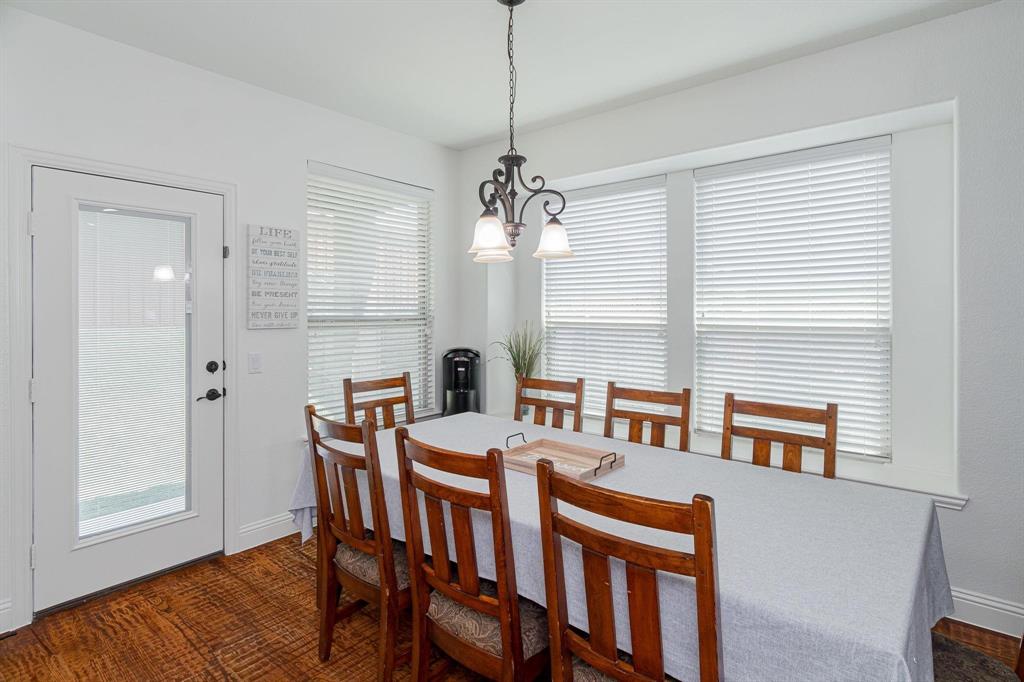 4210 Magnolia Road Melissa, TX 75454 - Photo 7 of 22 Wood-finish flooring, white walls, white trim, glass-paneled door, and a multi-pane window with white blinds