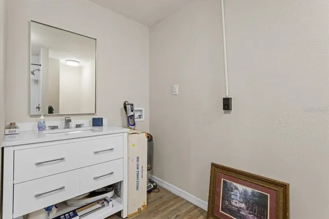 a bathroom with a sink a vanity and a mirror