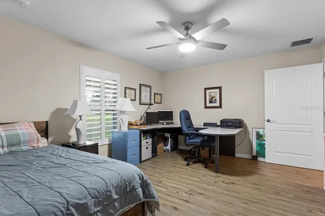 a bedroom that has a bed and a desk in it