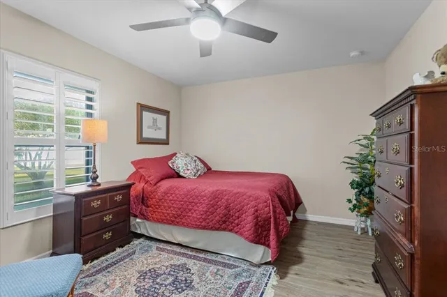 a bedroom with a bed and a potted plant