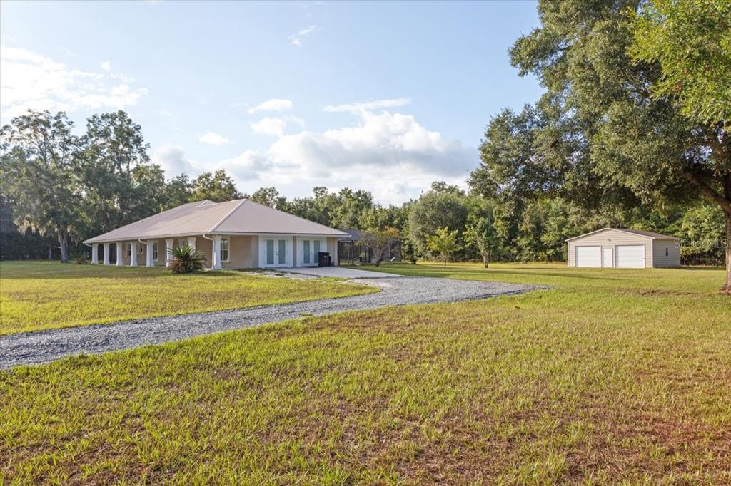4700 Southwest Wilson Springs Road Fort White, FL 32038 - Photo 2 of 41 a view of a swimming pool and trees in the background