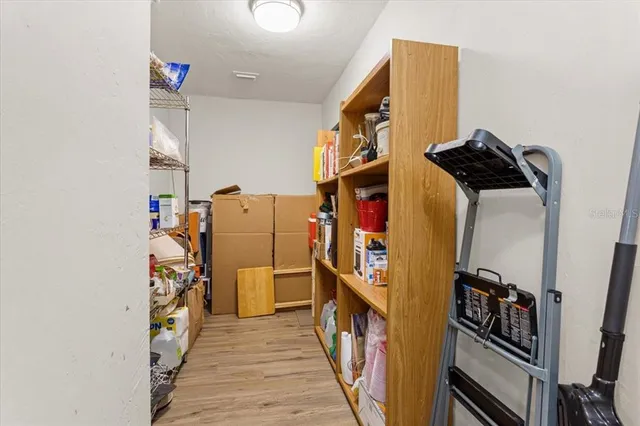 a view of a hallway with wooden floor and closet