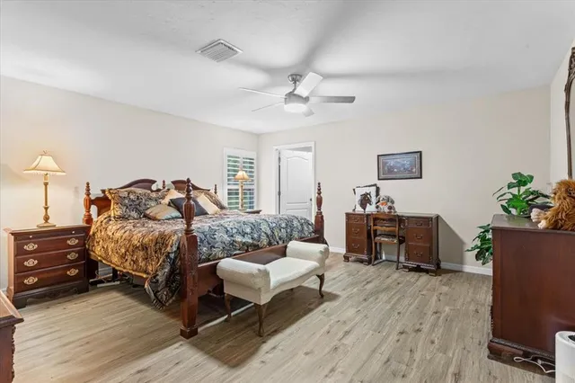 a bedroom with furniture and a wooden floor