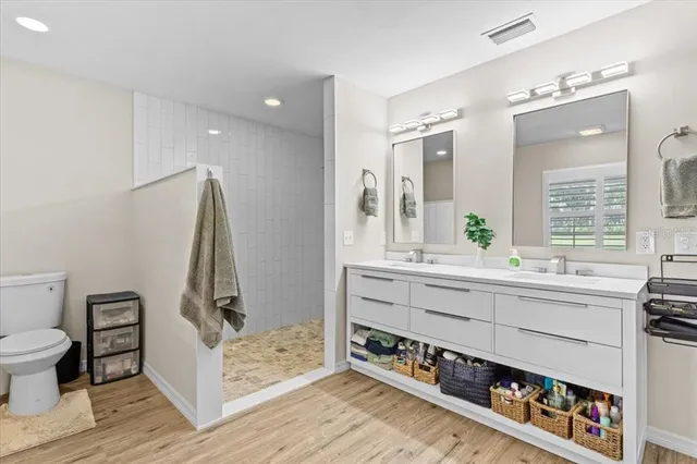 a view of kitchen with stainless steel appliances sink and wooden floor