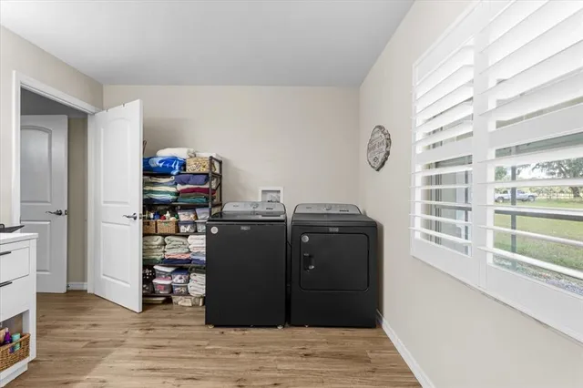 a view of a living room with furniture and wooden floor
