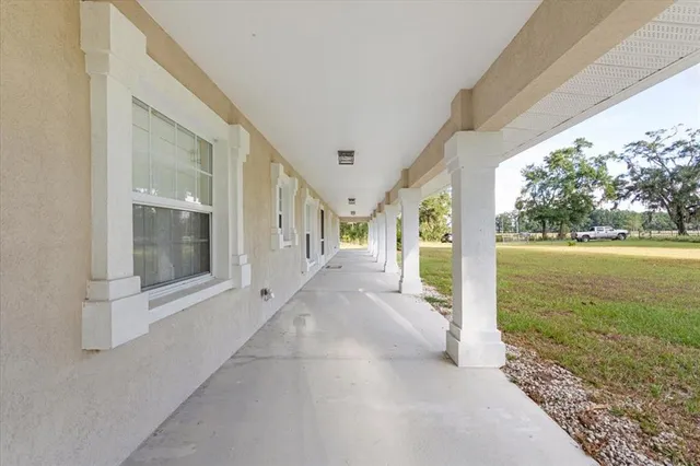 a view of a porch with furniture and garden