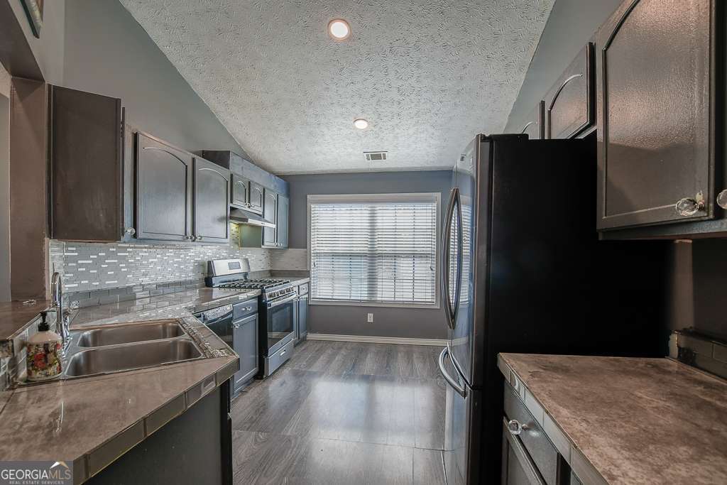 336 Shenandoah Circle Winder, GA 30680 - Photo 11 of 38 a kitchen with a sink stove and refrigerator