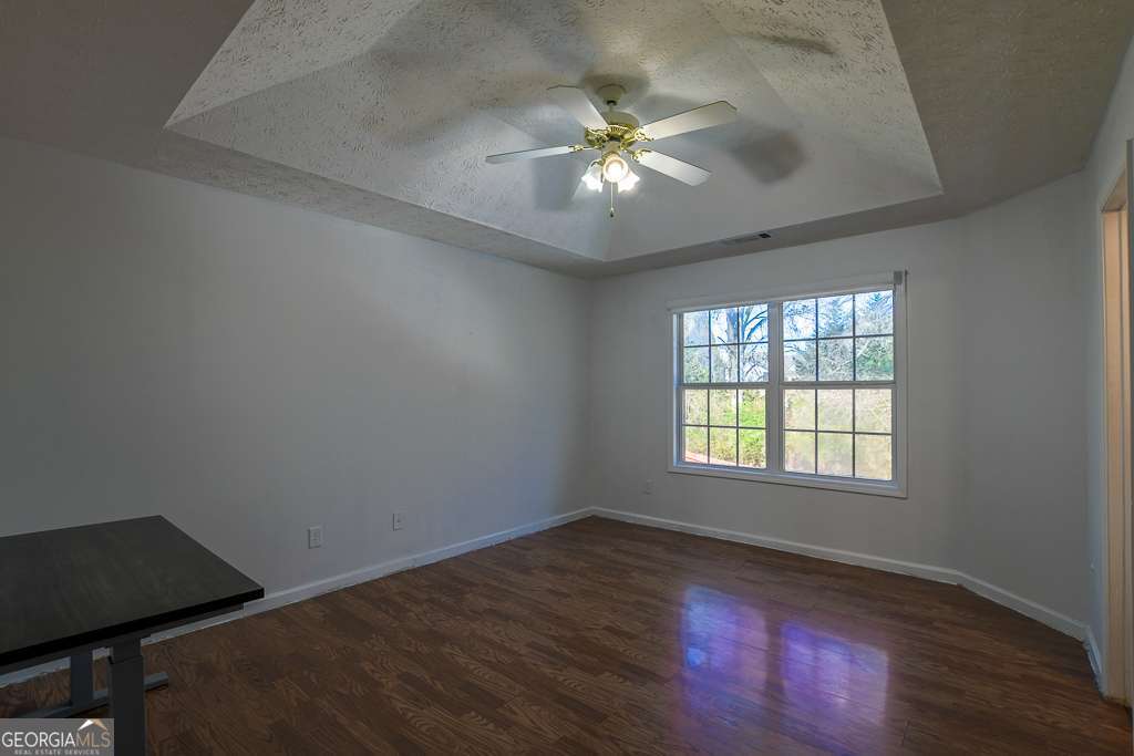 336 Shenandoah Circle Winder, GA 30680 - Photo 16 of 38 a view of an empty room with wooden floor and a window