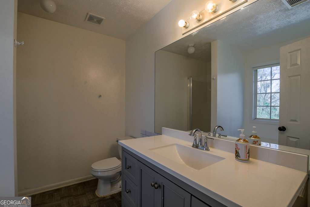 336 Shenandoah Circle Winder, GA 30680 - Photo 19 of 38 a bathroom with a granite countertop sink toilet and mirror