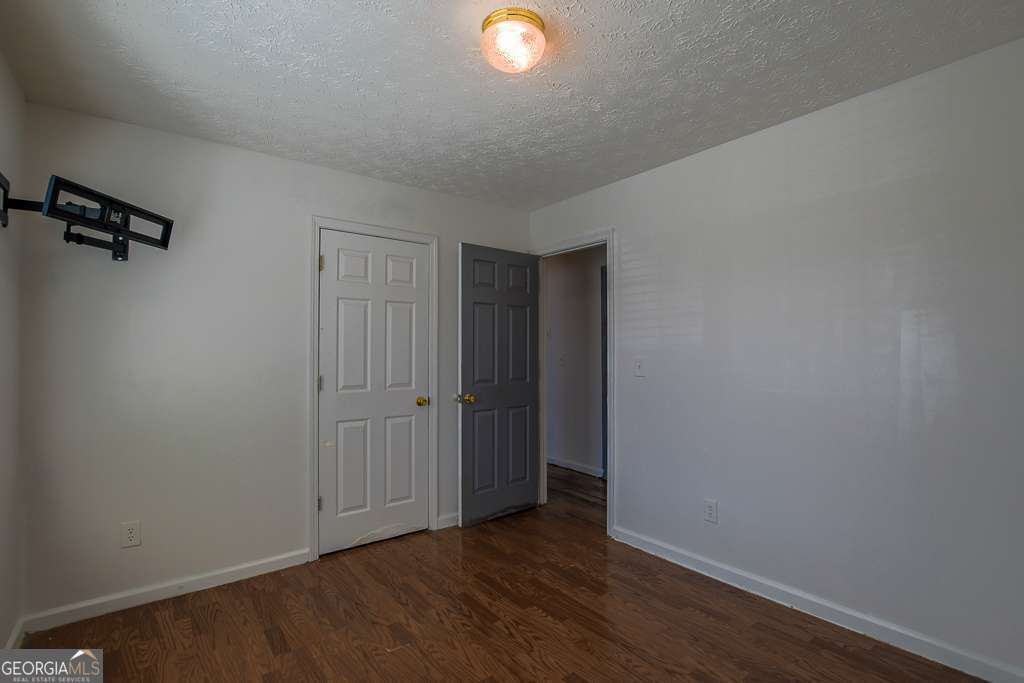 336 Shenandoah Circle Winder, GA 30680 - Photo 22 of 38 a view of an empty room with wooden floor and a window