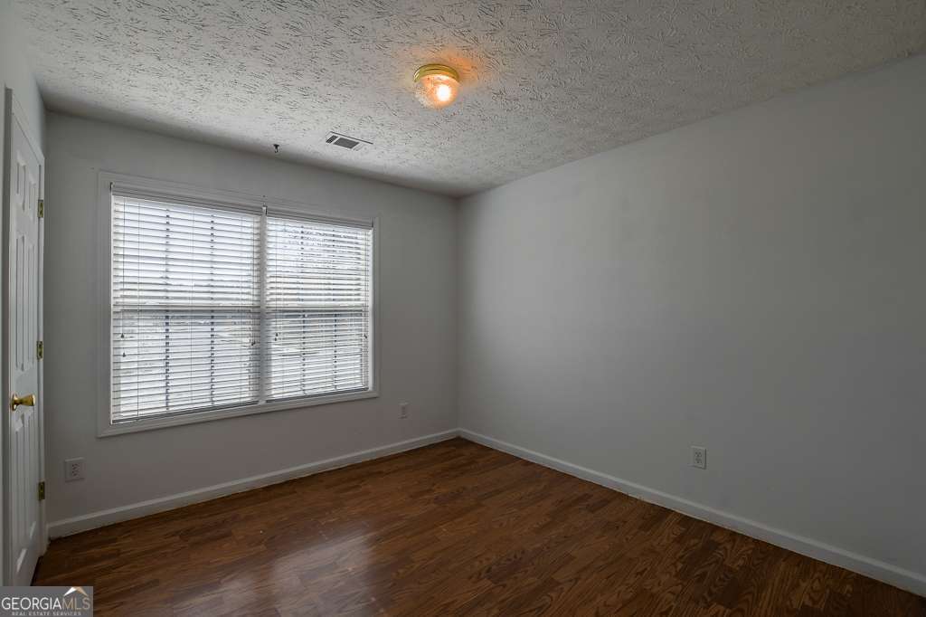 336 Shenandoah Circle Winder, GA 30680 - Photo 23 of 38 an empty room with wooden floor and windows