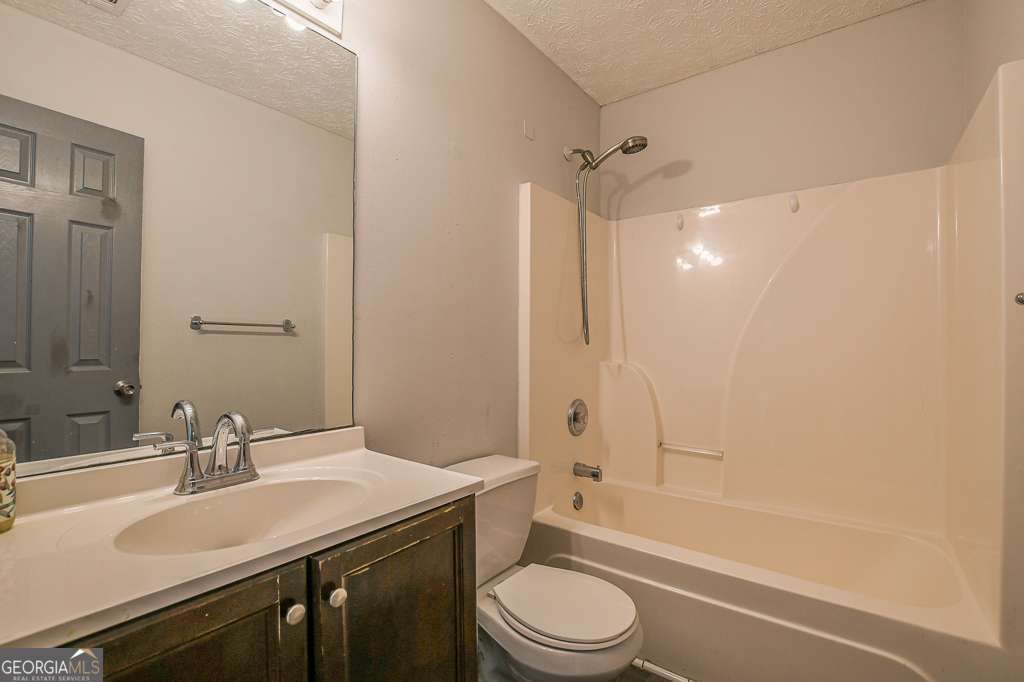 336 Shenandoah Circle Winder, GA 30680 - Photo 25 of 38 a bathroom with a bathtub shower sink vanity mirror and toilet