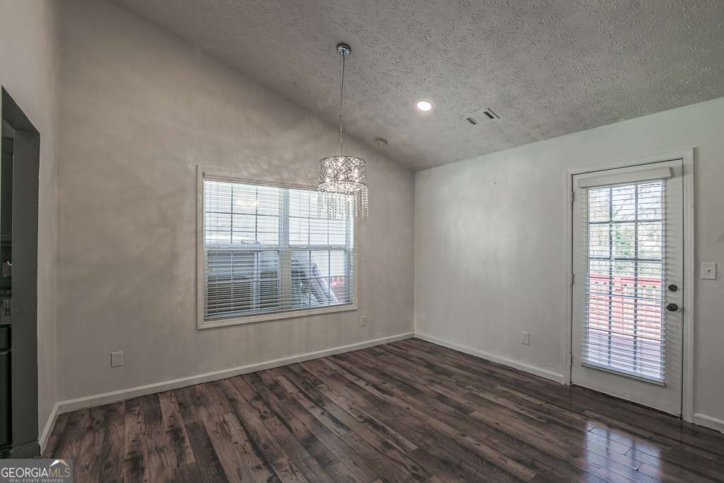 336 Shenandoah Circle Winder, GA 30680 - Photo 9 of 38 an empty room with wooden floor and windows