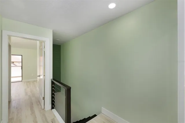 a view of hallway with wooden floor